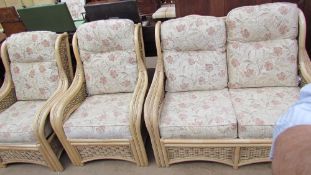 A three piece conservatory suite with floral upholstery