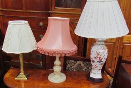 A brass table lamp together with two other table lamps