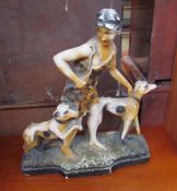 A plaster figure group of a lady and two dogs