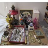 A cranberry glass oil lamp together with a brass oil lamp, Caithness glass paperweights,