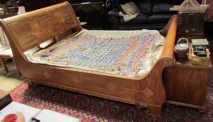 A King Size hardwood sleigh bed, with scroll over ends on bracket feet,