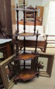 A Victorian marquetry decorated four tier whatnot together with a pair of gilt framed painted wall