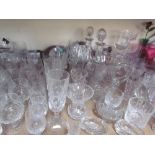 Glass decanters together with a large quantity of drinking glasses, cranberry glass jug,