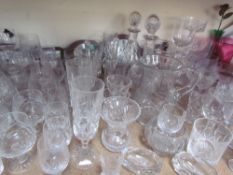 Glass decanters together with a large quantity of drinking glasses, cranberry glass jug,