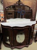 A Victorian walnut mirror back chiffonier with a mirror back above a three panelled mirror door on