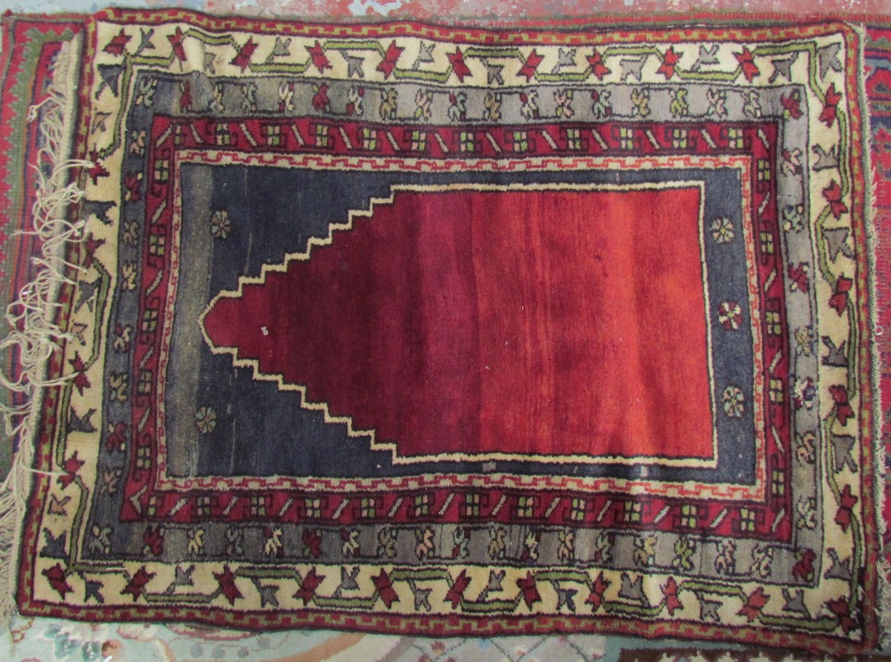 A red ground runner with a geometric design together with a prayer rug with central mihrab and a