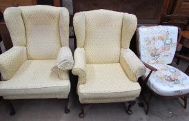 A pair of upholstered wing back arm chairs together with a mid 20th century upholstered chair