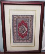 A miniature silk rug, with a red ground and central medallion and multiple guard stripes, 18.