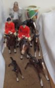 Two Beswick huntsmen in pink jackets on bay horses together with Beswick foals,