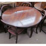 A Victorian mahogany extending dining table on four reeded legs together with a set of four