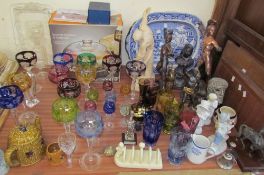 Assorted multicoloured wine glasses together with assorted gladiatorial figures, pottery figures,