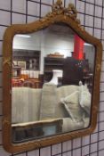 A gilt wall mirror together with an alphabet print and a photograph