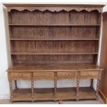 A 20th century dresser, the moulded cornice above three shelves,