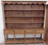 A 20th century dresser, the moulded cornice above three shelves,