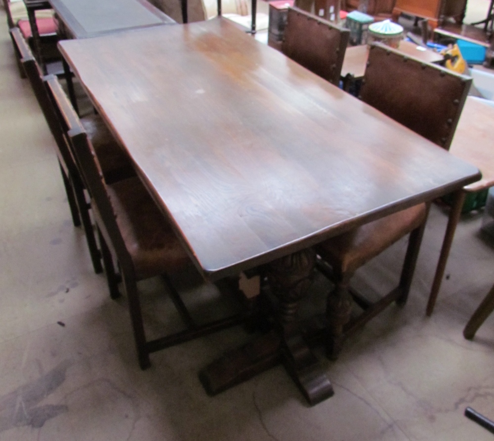 A 20th century oak refectory table and four leather dining chairs