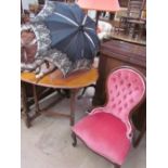A Victorian style mahogany spoon back nursing chair together with two parasols and an umbrella