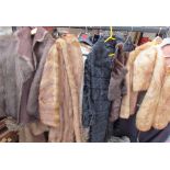 A three quarter length fur coat together with fur coats,