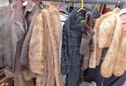 A three quarter length fur coat together with fur coats,