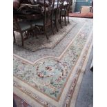 A large cream ground carpet with a central medallion,
