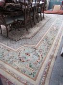 A large cream ground carpet with a central medallion,