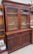 A Victorian mahogany bookcase with a moulded cornice above a pair of glazed doors,