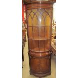 A reproduction mahogany standing corner cupboard with a glazed door of “D” section