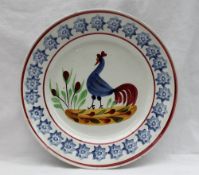 A Llanelly pottery plate, painted with a blue cockerel,