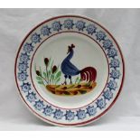 A Llanelly pottery plate, painted with a blue cockerel,