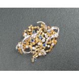 An 18ct yellow and white gold brooch set with nine round brilliant cut diamonds each approximately