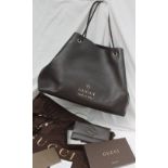 A brown leather Gucci Handbag, with a textured body, gilt logo with a braided handle, No.