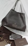 A brown leather Gucci Handbag, with a textured body, gilt logo with a braided handle, No.