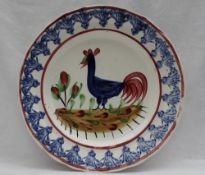 A Llanelly pottery plate, painted with a blue cockerel,