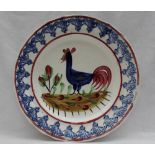 A Llanelly pottery plate, painted with a blue cockerel,