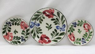A Llanelly pottery Persian Rose painted plate, in a black line border,