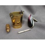 A brass pail match case, with a swing handle and strike to the base,