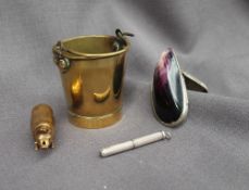 A brass pail match case, with a swing handle and strike to the base,