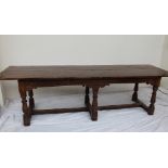 A 17th century style yew refectory table,