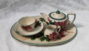 A Llanelly Art Pottery part cabaret set, comprising an oval tray, teapot, cream jug,