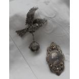 A Marcasite watch in the form of a bird in flight with a ball clock chained to its leg together