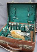 An Edwardian gentleman's leather travelling case, with outer protective covers,