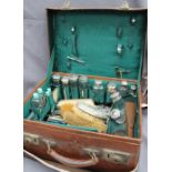 An Edwardian gentleman's leather travelling case, with outer protective covers,