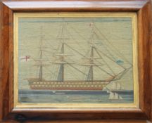 A Victorian Sailor's woolwork picture of a three masted ship with other boats in the foreground,