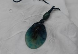 Almeric Walter - a pate de verre glass pendant moulded with a cricket in blues and greens on a