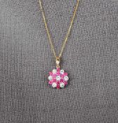 A ruby and diamond cluster pendant,