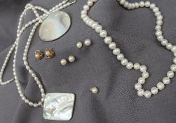 A pearl necklace with fifty-one regular pearls each approximately 8mm diameter to a 14ct gold clasp