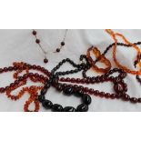 A Cherry red amber necklace, with graduated beads together with other amber necklaces,