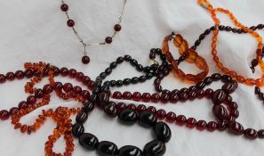 A Cherry red amber necklace, with graduated beads together with other amber necklaces,