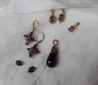 A pair of amethyst earrings of star shape to a yellow metal setting marked 9k together with another