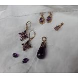 A pair of amethyst earrings of star shape to a yellow metal setting marked 9k together with another