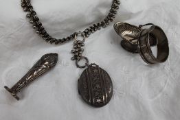 A late Victorian silver locket of oval form decorated with leaves and scrolls, Birmingham,